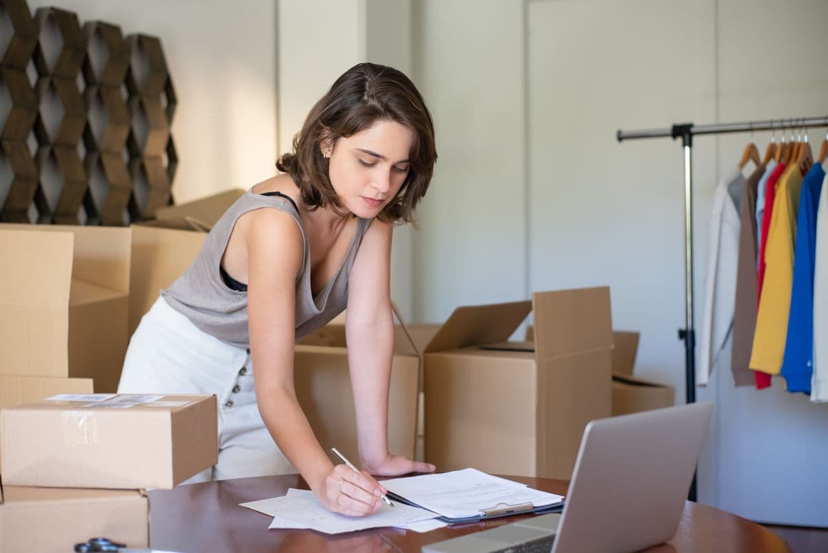 An entrepreneur setting up her online store from a home workspace